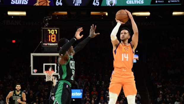 Dec 10, 2021; Phoenix, Arizona, USA; Phoenix Suns guard Landry Shamet (14) shoots over Boston Celtics guard Dennis Schroder (71) during the second half at Footprint Center. Mandatory Credit: Joe Camporeale-USA TODAY Sports